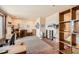 Office space with multiple work desks and shelves with a small bedroom space in the corner at 8611 Coachlight Way, Littleton, CO 80125
