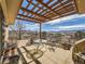 Covered patio with seating offers unobstructed views of the surrounding landscape at 8611 Coachlight Way, Littleton, CO 80125