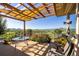 Covered patio featuring a pergola, dining area, and beautiful views of rolling hills at 8611 Coachlight Way, Littleton, CO 80125