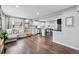 Open concept living room and kitchen with hardwood floors, a comfortable couch, and plenty of natural light at 1010 S Osceola St, Denver, CO 80219