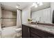 Stylish bathroom with granite counters, tiled shower, and modern fixtures at 409 Terry St # D, Longmont, CO 80501