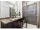 Sleek bathroom featuring granite countertop, modern shower with glass door, and updated fixtures at 409 Terry St # D, Longmont, CO 80501