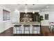 Stylish kitchen island with granite countertop, pendant lighting, and dark cabinets, perfect for entertaining at 409 Terry St # D, Longmont, CO 80501