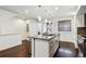 Modern kitchen featuring island with sink, bar stool, stainless steel appliances and dark wood floors at 409 Terry St # D, Longmont, CO 80501
