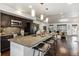 Modern kitchen features a large island with bar seating, dark cabinets, and stainless steel appliances at 409 Terry St # D, Longmont, CO 80501