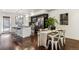 Open-concept kitchen with dark cabinetry, stainless steel appliances, dining area and wood floors at 409 Terry St # D, Longmont, CO 80501