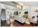 Open floor plan showing hardwood floors, seating area, dining and kitchen with natural light at 409 Terry St # D, Longmont, CO 80501