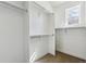 Spacious walk-in closet with ample shelving, hanging rods and a bright window at 409 Terry St # D, Longmont, CO 80501