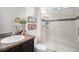 Cozy bathroom features a glass shower stall and dark vanity with stone tile countertop at 9080 Fig St, Arvada, CO 80005