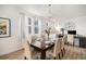 Dining room with hardwood floors, seating for six, chandelier, and decorative clock at 9080 Fig St, Arvada, CO 80005