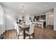 Well-lit dining room next to the kitchen featuring a wooden table and white chairs at 9080 Fig St, Arvada, CO 80005