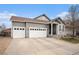 Charming home with a 3-car garage, neutral siding, and landscaped front yard at 9080 Fig St, Arvada, CO 80005