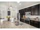 Charming kitchen featuring stainless steel appliances, granite countertops and dark wood cabinets at 9080 Fig St, Arvada, CO 80005