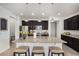 Bright kitchen featuring stainless steel appliances, granite countertops, dark wood cabinets and an island at 9080 Fig St, Arvada, CO 80005