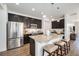 Open concept kitchen with granite counters, stainless steel appliances, and pendant lighting at 9080 Fig St, Arvada, CO 80005