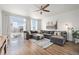 Comfortable living room boasts a gray sectional sofa, area rug, and a ceiling fan at 9080 Fig St, Arvada, CO 80005