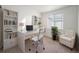 Bright office space featuring a modern desk, a white chair, a window and natural light at 9080 Fig St, Arvada, CO 80005