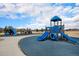 Community playground with multiple play structures, slides, and a cushioned play area at 9080 Fig St, Arvada, CO 80005