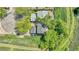 Aerial view of a property with mature trees, a well-maintained lawn and a nearby walking trail at 8032 Lee Ct, Arvada, CO 80005