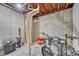 Unfinished basement with exposed ceiling, cement walls, and utility pipes at 8032 Lee Ct, Arvada, CO 80005