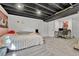Carpeted basement featuring exposed ceiling, bed, and desk space for multiple uses at 8032 Lee Ct, Arvada, CO 80005