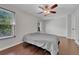 Well-lit bedroom with hardwood floors, a ceiling fan, and natural light from large windows at 8032 Lee Ct, Arvada, CO 80005