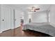 Spacious bedroom features hardwood floors, ceiling fan, and access to hallway at 8032 Lee Ct, Arvada, CO 80005