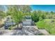 Lovely home with a well-maintained lawn, mature trees, and a welcoming driveway for easy access and parking at 8032 Lee Ct, Arvada, CO 80005
