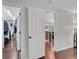 Bright hallway with hardwood floors leads to walk-in closet and dining area upstairs at 8032 Lee Ct, Arvada, CO 80005