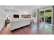 Bright living room boasts a fireplace, wood floors, and sliding glass doors to the deck at 8032 Lee Ct, Arvada, CO 80005