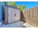 Durable outdoor shed with stylish double doors and ample storage space, complemented by a sturdy wooden fence at 8032 Lee Ct, Arvada, CO 80005