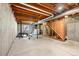 Unfinished basement offering potential with exposed beams, concrete floors, and utility connections at 338 Pheasant Run, Louisville, CO 80027