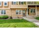 Inviting brick townhome with manicured lawn and charming architectural details at 338 Pheasant Run, Louisville, CO 80027