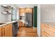 Modern kitchen with stainless steel appliances, wood cabinets, and granite counters at 338 Pheasant Run, Louisville, CO 80027