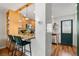 Open kitchen with wooden cabinets, stainless steel appliances, and breakfast bar seating at 338 Pheasant Run, Louisville, CO 80027