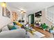 Comfortable living area featuring a large sofa, open kitchen, and natural light at 338 Pheasant Run, Louisville, CO 80027