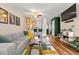 Stylish living room open to the kitchen featuring a cozy sofa and hardwood floors at 338 Pheasant Run, Louisville, CO 80027