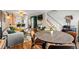 Spacious open-concept living area with stairs, dining, and seamless kitchen view at 338 Pheasant Run, Louisville, CO 80027