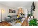 Bright living room featuring modern gray sofa, stylish rug and open floor plan at 338 Pheasant Run, Louisville, CO 80027