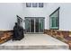 Covered back patio featuring a sliding glass door, brick accents, and a barbecue grill at 690 W 172Nd Pl, Broomfield, CO 80023