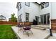 Exterior view of a well-maintained backyard with a patio, seating, and lush green lawn at 690 W 172Nd Pl, Broomfield, CO 80023