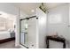 Stylish bathroom featuring a glass door shower, dark fixtures, and tasteful decorations at 690 W 172Nd Pl, Broomfield, CO 80023