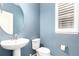 Stylish powder room featuring a modern sink and a round mirror at 690 W 172Nd Pl, Broomfield, CO 80023