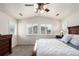 Primary bedroom featuring vaulted ceilings, a ceiling fan, and three shuttered windows overlooking the neighborhood at 690 W 172Nd Pl, Broomfield, CO 80023