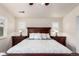 This primary bedroom features a wooden bedframe, white linens, side tables, and matching lamps at 690 W 172Nd Pl, Broomfield, CO 80023