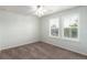 Bright bedroom featuring neutral walls, carpet flooring, and two windows with plantation shutters at 690 W 172Nd Pl, Broomfield, CO 80023