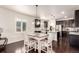 Charming dining area with stylish table and chairs with seamless transition to kitchen area at 690 W 172Nd Pl, Broomfield, CO 80023