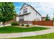 Beautiful home featuring stone accents, a well-manicured lawn, and a walkway to the side yard at 690 W 172Nd Pl, Broomfield, CO 80023