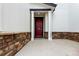 Charming front porch with a red front door framed by white columns and brick accents at 690 W 172Nd Pl, Broomfield, CO 80023