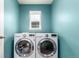 Well-lit laundry room with a window and modern, front-loading LG washer and dryer at 690 W 172Nd Pl, Broomfield, CO 80023